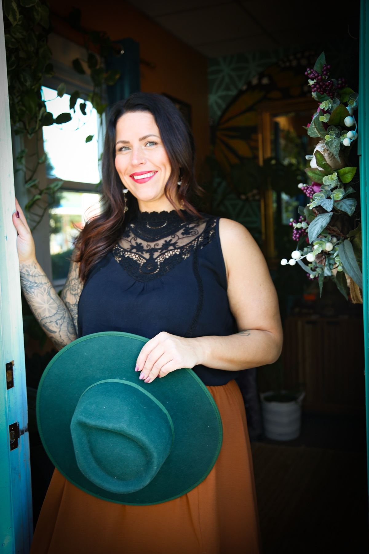 Kate Gajewski smiling in the doorway at The Lightness of Being